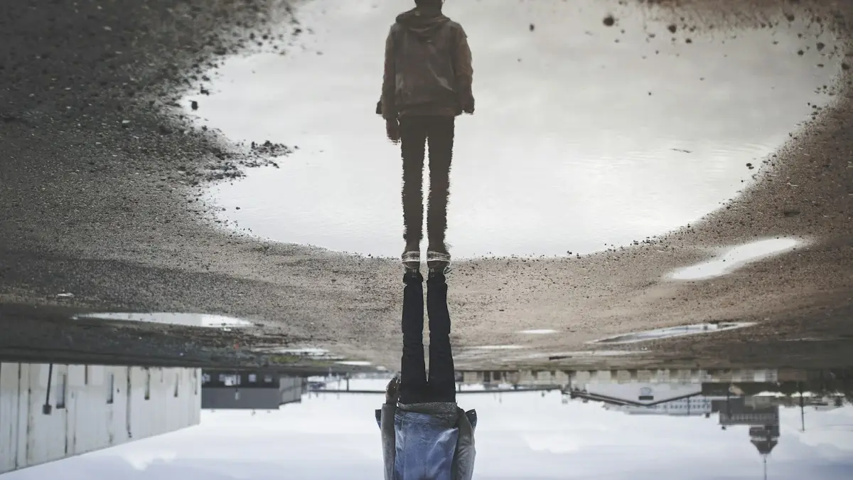 A person's reflection upside down in a puddle on the ground