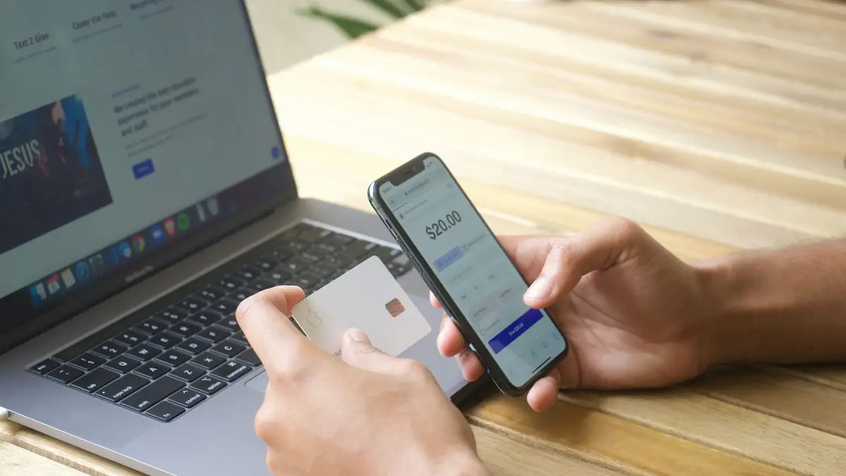 A person paying online with a credit card and a smartphone