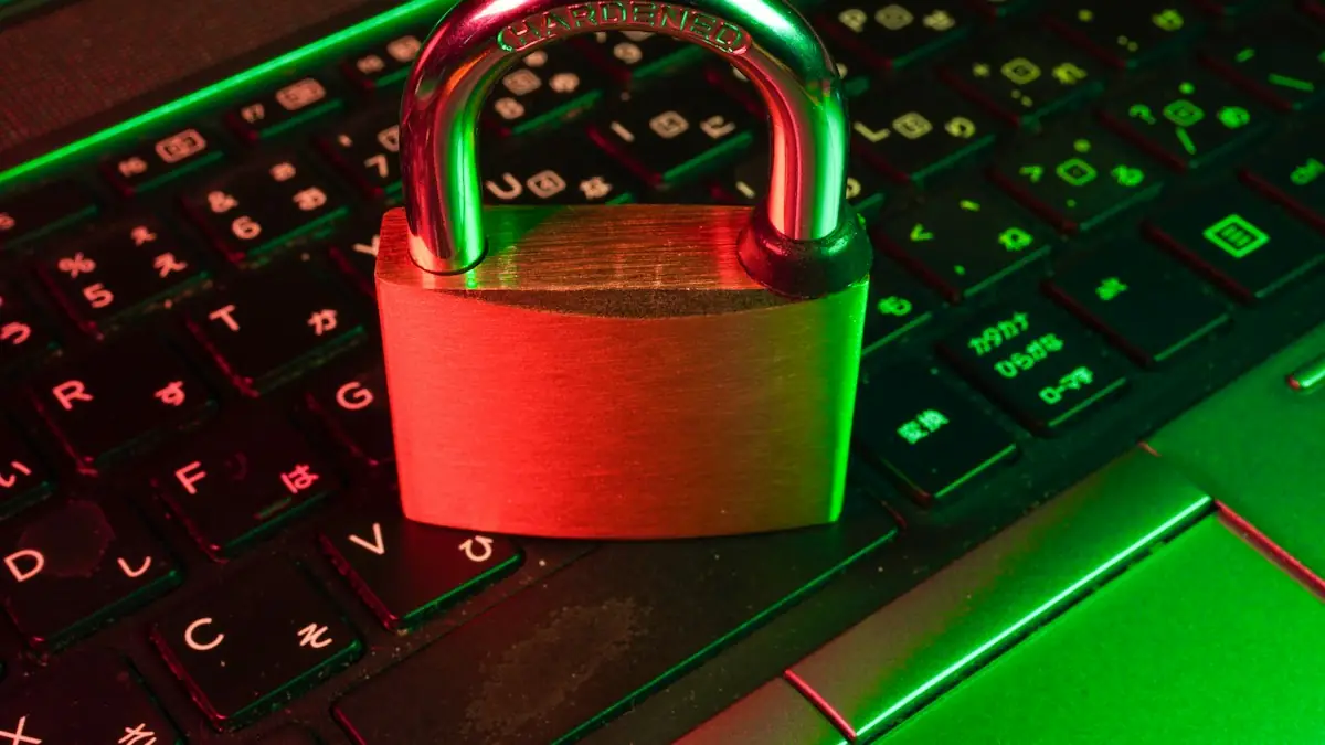 A red padlock resting on a computer keyboard