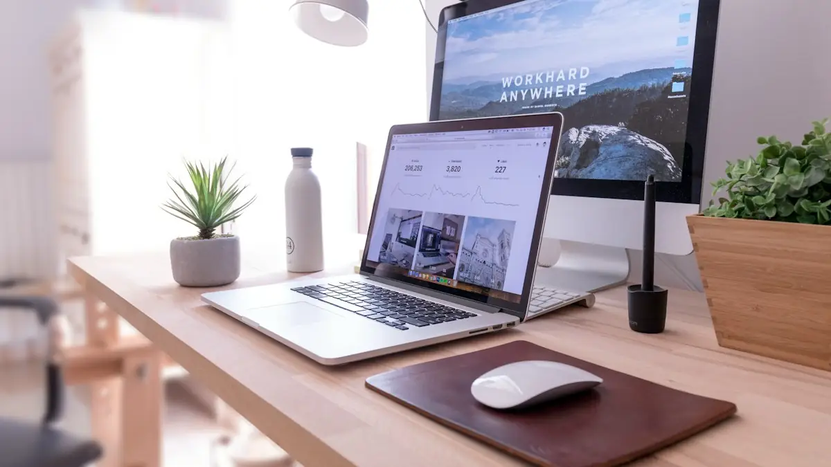 MacBook Pro on table beside white iMac and Magic Mouse